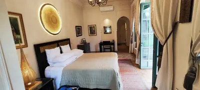 a bedroom with a bed and a hallway with a table at Marrakech, villa 7 Harmonia, pour 6 personnes avec piscine privée in Marrakech