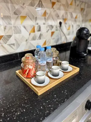 a tray with cups and bottles of water on a counter at The Cosy Duplex With Gym Access & Near Mall, Palooza in Marrakech