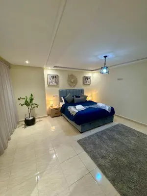 a bedroom with a blue bed and a potted plant at The Cosy Duplex With Gym Access & Near Mall, Palooza in Marrakech