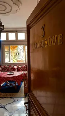 a door in a room with a table and a bed at Residence Koutoubienne in Marrakech