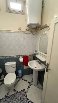 a bathroom with a toilet and a sink and a mirror at Residence Koutoubienne in Marrakech