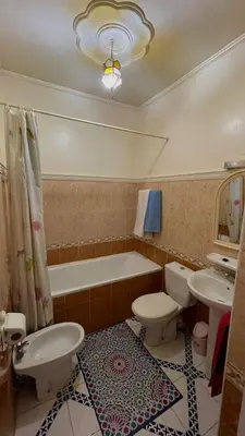 a bathroom with a tub and a toilet and a sink at Residence Koutoubienne in Marrakech