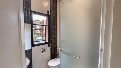 a bathroom with a toilet and a window at Spacious Apartment 102m2 3 Bedrooms 2 Bathrooms 8 Guests Elevator Self Check in in Marrakech