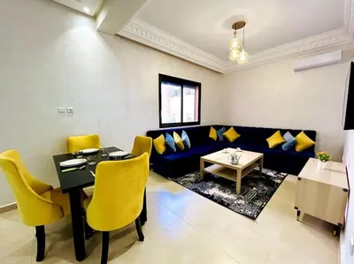 a living room with a blue couch and yellow chairs at Marrakech 2 Bedroom Family Apartment in Marrakech