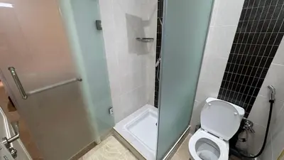 a bathroom with a toilet and a glass shower at Marrakech 2 Bedroom Family Apartment in Marrakech