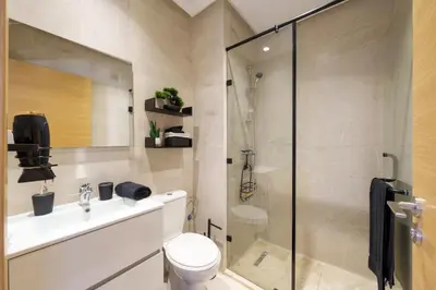 a bathroom with a toilet and a glass shower at Appart View Pool - 3 Rooms - Optical Fiber in Marrakech
