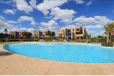 a large swimming pool in a resort with apartments at Appart-Oasis/3 Piscines/2 Terrasses in Marrakech