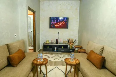 a living room with a couch and two tables at The Skyline Stay in Marrakech