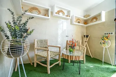 a living room with chairs and a table with flowers at The Skyline Stay in Marrakech