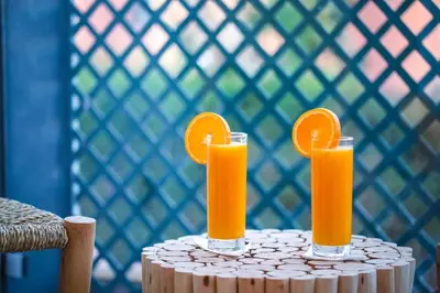 two glasses of orange juice sitting on a table at Marrakech Apartments in Marrakech