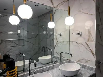a bathroom with two sinks and two mirrors at Marrakech Apartments in Marrakech