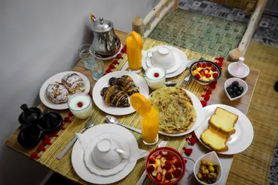 a table with plates of breakfast food on it at Marrakech Apartments in Marrakech