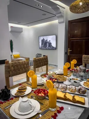 a table with food on it in a living room at Marrakech Apartments in Marrakech