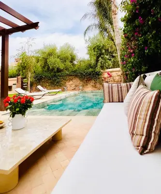a patio with a bench and a swimming pool at Villa Jenna in Marrakech