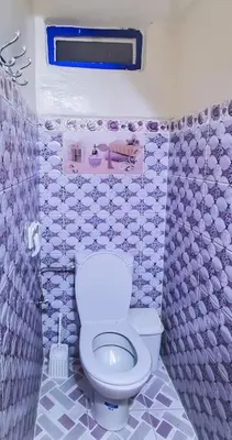 a bathroom with a white toilet and a sink at Riad Sultana - 10 min à pied de Jemaa El Fna in Marrakech