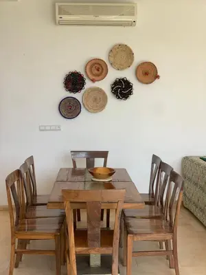 a dining room table with chairs and hats on the wall at La villa Berbère - Famille uniquement in Marrakech