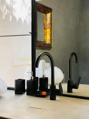 a bathroom counter with two sinks and a mirror at Riyad Lion Rouge in Marrakech