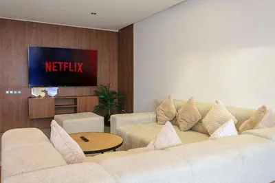 a living room with a couch and a tv at The Gallery Suite – Marrakech Centre in Marrakech