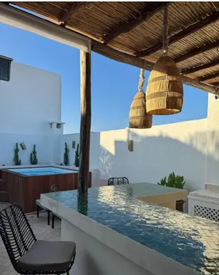 a patio with a table and chairs and a pool at Riad Bella Kasbah in Marrakech