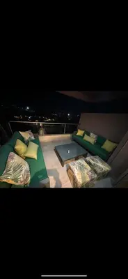 two beds sitting on top of a balcony at night at Prestigia Golf Vue Atlas et Piscine in Marrakech