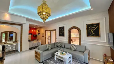 a living room with a couch and a chandelier at Luxurious Villa with private pool, Jacuzzi & Cuisinière in Marrakech