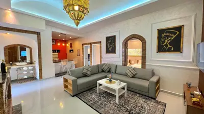 a living room with a couch and a table at Luxurious Villa with private pool, Jacuzzi & Cuisinière in Marrakech