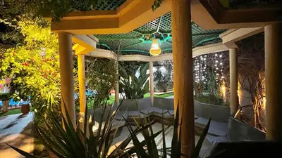a conservatory with a patio with plants and a ceiling at Luxurious Villa with private pool, Jacuzzi & Cuisinière in Marrakech