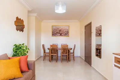 a dining room with a table and chairs at Appartement 2 chambres Aéroport in Marrakech