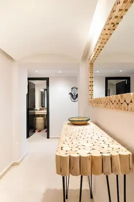 a dining room with a table and stools at C-Appartement de luxe plein centre de gueliz avec piscine parking wifi netflix in Marrakech