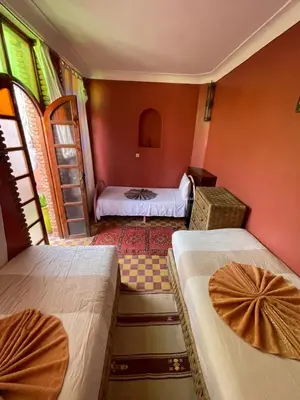 a room with two beds in a room at Riad Lwalidin in Marrakech