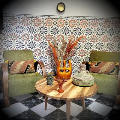 a living room with a table with a vase on it at Riad traditionnel de charme 3 chambres in Marrakech