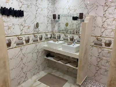 a bathroom with two sinks and a mirror at RIAD & SPA SOUS LE SOLEIL CHEZ Jérôme & Paméla in Marrakech