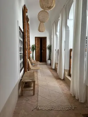 a hallway with chairs and a chandelier at Neroli le Riad, idéalement situé in Marrakech