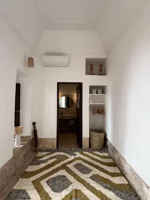 a room with a hallway with a rug on the floor at Neroli le Riad, idéalement situé in Marrakech