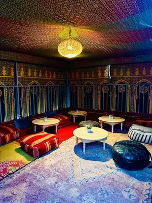 a room with couches and tables in a room with a ceiling at Oasis Medina Hostel in Marrakech