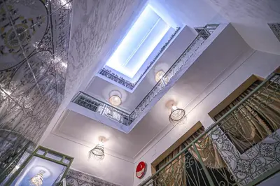 a building with a staircase and a window on the ceiling at Oasis Medina Hostel in Marrakech