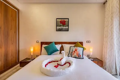 a bed with a heart shaped bowl on it at Vittoria Guest House Marrakech in Marrakech