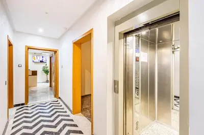 a hallway with a door and a tile floor at Vittoria Guest House Marrakech in Marrakech