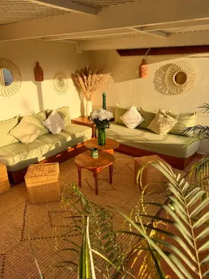 a living room with couches and a table at Riad privé Sadaka Bassin Rooftop in Marrakech