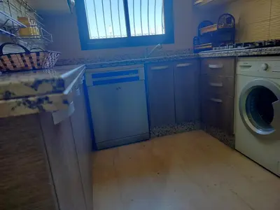 a kitchen with a washing machine and a washer at résidence assafa central H26 in Marrakech