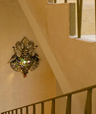 a chandelier hanging on the wall next to a staircase at Riad Romeo in Marrakech