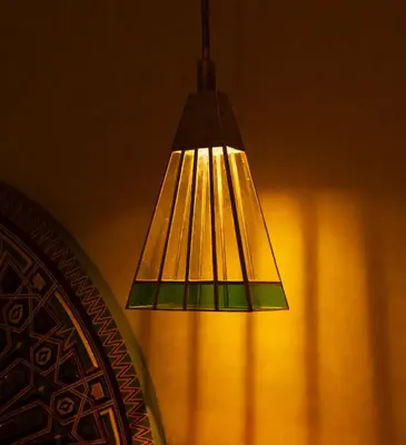 aendant light hanging from a wall next to a window at Riad Romeo in Marrakech