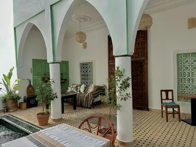a living room with a couch and a table and chairs at Riad Ocallaghan in Marrakech