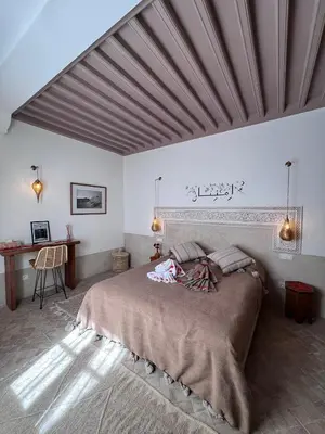 a bedroom with a large bed and a desk at Riad Casa Dolce Marrakech Médina in Marrakech