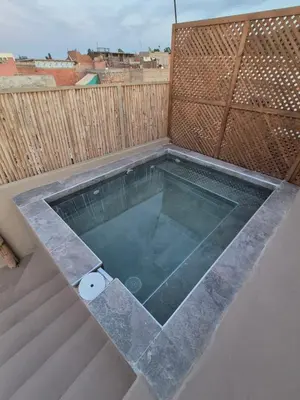 a swimming pool on a patio with a fence at Riad Casa Dolce Marrakech Médina in Marrakech