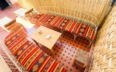 an overhead view of a room with a table and carpet at Riad Fridi in Marrakech