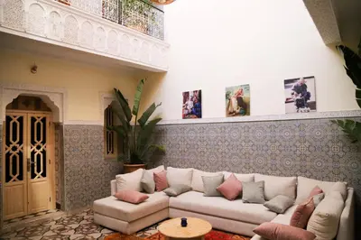 a living room with a couch and a table at Riad Fridi in Marrakech