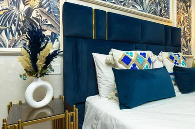 a blue bedroom with a bed with a blue headboard at E-Appartement de luxe centre Gueliz piscine parking fibre netflix in Marrakech