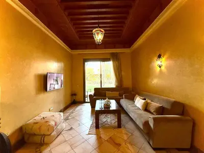 a living room with a couch and a table at Les jardins de la palmeraie résidence touristique in Marrakech