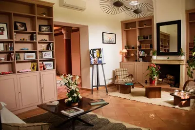 a living room with a fireplace and a table at Villa Prestige Mansourya in Marrakech